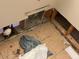Image shows a bathroom with damaged tile floor and exposed plumbing at 46157 W Holly Dr, Maricopa, AZ 85139