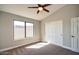 Spacious bedroom with vaulted ceiling, large window, and double doors to closet at 2206 E Sapium Way, Phoenix, AZ 85048