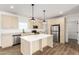 Kitchen with island, stainless steel appliances, and light cabinets at 1023 N Ralston Rd, Maricopa, AZ 85139