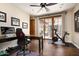 Home office with hardwood floors, large windows, and an exercise bike at 38749 N 104Th Way, Scottsdale, AZ 85262