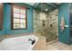 Bathroom features a walk-in shower, soaking tub, and stylish tilework at 38749 N 104Th Way, Scottsdale, AZ 85262