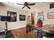Home office with hardwood floors, built-in desk and exercise bike at 38749 N 104Th Way, Scottsdale, AZ 85262