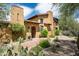 Spanish-style home with a welcoming front entrance and landscaping at 38749 N 104Th Way, Scottsdale, AZ 85262