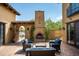 Outdoor patio area with seating and a fireplace at 38749 N 104Th Way, Scottsdale, AZ 85262