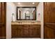 Double vanity bathroom with granite countertops and dark wood cabinets at 38749 N 104Th Way, Scottsdale, AZ 85262