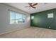 Bedroom with ceiling fan and green accent wall at 5139 N 185Th Ave, Litchfield Park, AZ 85340