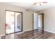 Bedroom with wood-look floors and sliding glass doors to balcony at 1972 S Clubhouse Dr, Casa Grande, AZ 85194