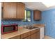 Bright kitchen features wood cabinets, blue tile backsplash, and microwave at 1972 S Clubhouse Dr, Casa Grande, AZ 85194
