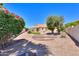 Backyard with garden area, gravel, and mature trees at 1247 E Marketplace Se Way, Phoenix, AZ 85048