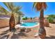 Refreshing pool surrounded by desert landscaping and palm trees at 1247 E Marketplace Se Way, Phoenix, AZ 85048