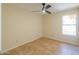 Simple bedroom with ceiling fan and tile flooring at 1247 E Marketplace Se Way, Phoenix, AZ 85048