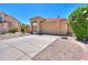 Tan stucco home with tile roof, double garage, and desert landscaping at 1247 E Marketplace Se Way, Phoenix, AZ 85048