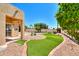 Landscaped backyard with artificial turf and desert landscaping at 1247 E Marketplace Se Way, Phoenix, AZ 85048