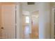 A hallway with tile floors and doors to other rooms at 1247 E Marketplace Se Way, Phoenix, AZ 85048