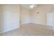 Bright bedroom with tile floors and a door to bathroom at 1247 E Marketplace Se Way, Phoenix, AZ 85048