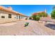 Brick pathway leads to a spacious backyard with desert landscaping at 1247 E Marketplace Se Way, Phoenix, AZ 85048