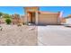 Tan stucco home with tile roof, double garage, and desert landscaping at 1247 E Marketplace Se Way, Phoenix, AZ 85048