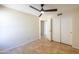 Bedroom with ceiling fan, tile floors, and double doors at 1247 E Marketplace Se Way, Phoenix, AZ 85048