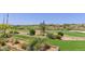 Scenic view of a lush golf course with manicured lawns and desert landscaping at 41417 N Clear Crossing Rd, Anthem, AZ 85086