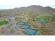 Community overview featuring tennis courts, a golf course, and a pond at 41417 N Clear Crossing Rd, Anthem, AZ 85086