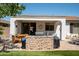Covered patio with built-in BBQ, seating area, and lush landscaping at 41417 N Clear Crossing Rd, Anthem, AZ 85086
