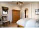 Spacious bedroom with wood floors, large closet, and a comfy sitting area at 10728 E Cottontail Ln, Scottsdale, AZ 85255