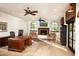 Home office with hardwood floors, large windows, and a fireplace at 10728 E Cottontail Ln, Scottsdale, AZ 85255