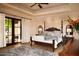 Main bedroom with a king-size bed and access to a private patio at 10728 E Cottontail Ln, Scottsdale, AZ 85255