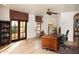 Bright office with hardwood floors, built-in shelving, and French doors at 10728 E Cottontail Ln, Scottsdale, AZ 85255