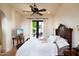 Serene bedroom with a king-size bed, hardwood floors, and French doors at 10728 E Cottontail Ln, Scottsdale, AZ 85255