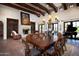 Elegant dining room with a large table and wood beam ceilings at 10728 E Cottontail Ln, Scottsdale, AZ 85255