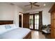 Bright bedroom with French doors leading to a private patio and hardwood floors at 10728 E Cottontail Ln, Scottsdale, AZ 85255