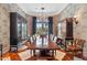 Formal dining room features a long wood table and ornate chandelier at 9926 E Kemper Way, Scottsdale, AZ 85255