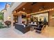 Relaxing covered patio with fireplace, comfortable seating, and views at 9926 E Kemper Way, Scottsdale, AZ 85255