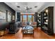 Sophisticated sitting room with built-in shelving and balcony access at 9926 E Kemper Way, Scottsdale, AZ 85255