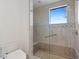Large walk-in shower with glass enclosure, tiled walls, and built-in seat at 9926 E Kemper Way, Scottsdale, AZ 85255