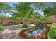 Landscaped backyard oasis with a fountain, patio furniture, and lush greenery at 9926 E Kemper Way, Scottsdale, AZ 85255