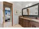 Double vanity bathroom with marble countertops and large mirror at 9926 E Kemper Way, Scottsdale, AZ 85255