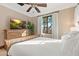 Bright bedroom with a wooden dresser, large windows, and a ceiling fan at 9926 E Kemper Way, Scottsdale, AZ 85255