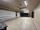 Spacious three-car garage with built-in storage cabinets and epoxy flooring at 9926 E Kemper Way, Scottsdale, AZ 85255