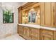 Bathroom with vanity, custom cabinetry and window with sheer curtains at 9926 E Kemper Way, Scottsdale, AZ 85255