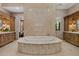 Large bathroom with a spacious soaking tub, double vanities, and marble flooring at 9926 E Kemper Way, Scottsdale, AZ 85255