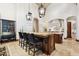 Island kitchen with breakfast bar, dark wood cabinetry, and granite counters at 9926 E Kemper Way, Scottsdale, AZ 85255