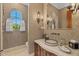 Stylish powder room with an ornate sink and decorative mirror at 9926 E Kemper Way, Scottsdale, AZ 85255