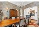Elegant dining room featuring a large wood table, chandelier, and ornate cabinetry at 9926 E Kemper Way, Scottsdale, AZ 85255