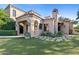 Elegant home exterior with a landscaped lawn and stone pathway at 9926 E Kemper Way, Scottsdale, AZ 85255