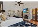 Luxurious main bedroom with a king-size bed, fireplace, and access to a private patio at 9926 E Kemper Way, Scottsdale, AZ 85255