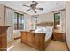 Spacious bedroom with a wooden bed frame, plenty of natural light and ceiling fan at 9926 E Kemper Way, Scottsdale, AZ 85255