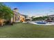 Expansive backyard oasis with a pool, spa, and lush lawn at 9926 E Kemper Way, Scottsdale, AZ 85255