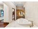 Luxurious bathroom with a soaking tub, double vanities and a separate toilet area at 9926 E Kemper Way, Scottsdale, AZ 85255